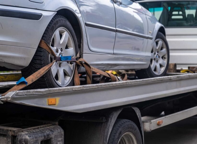 Loaded broken car on a tow truck. Car being towed. Damage vehicle after crash accident